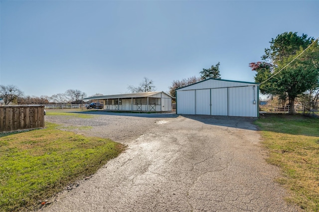 exterior space featuring an outdoor structure and a front lawn