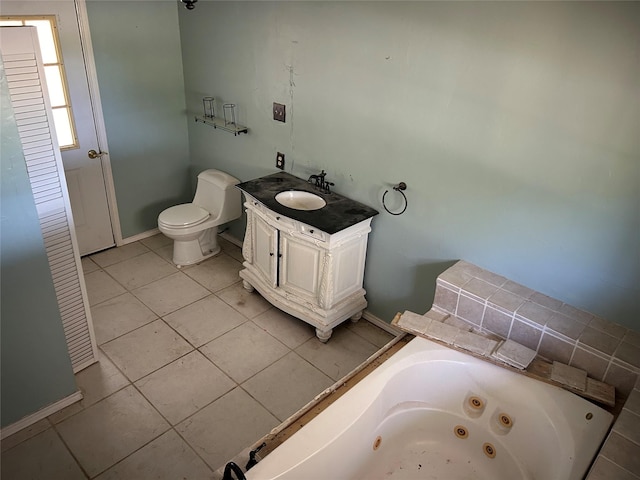 bathroom featuring tile patterned flooring, vanity, toilet, and a washtub