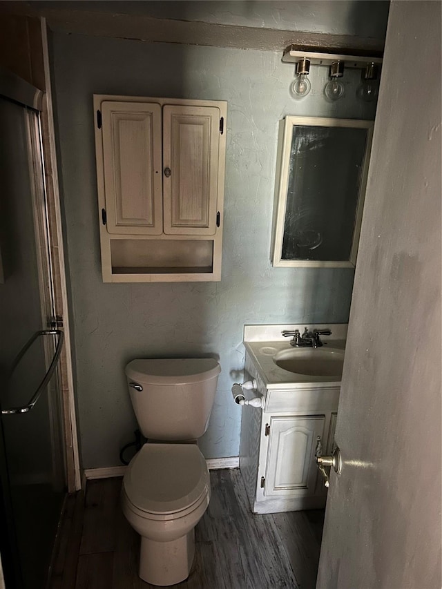 bathroom featuring hardwood / wood-style floors, vanity, and toilet