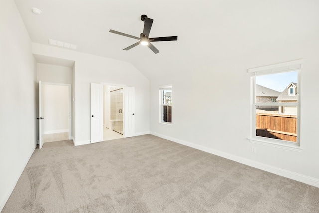 unfurnished bedroom with carpet flooring, vaulted ceiling, visible vents, and baseboards