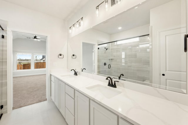 full bath with double vanity, a shower stall, a sink, and tile patterned floors