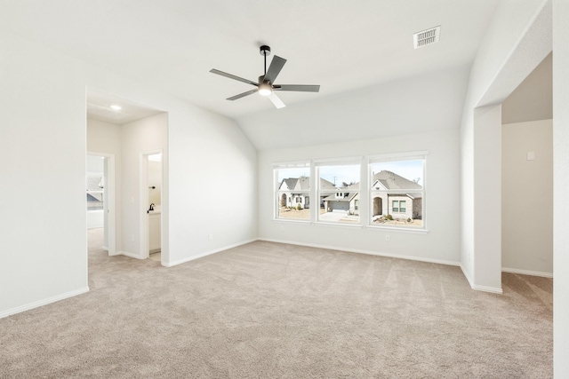 interior space with lofted ceiling, baseboards, visible vents, and a ceiling fan