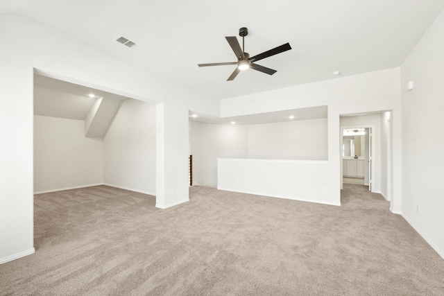 interior space with carpet floors, visible vents, and a ceiling fan