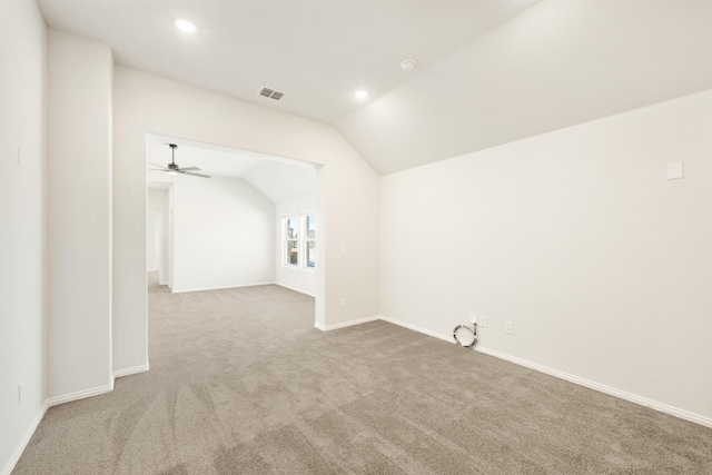 carpeted spare room featuring recessed lighting, visible vents, vaulted ceiling, and baseboards