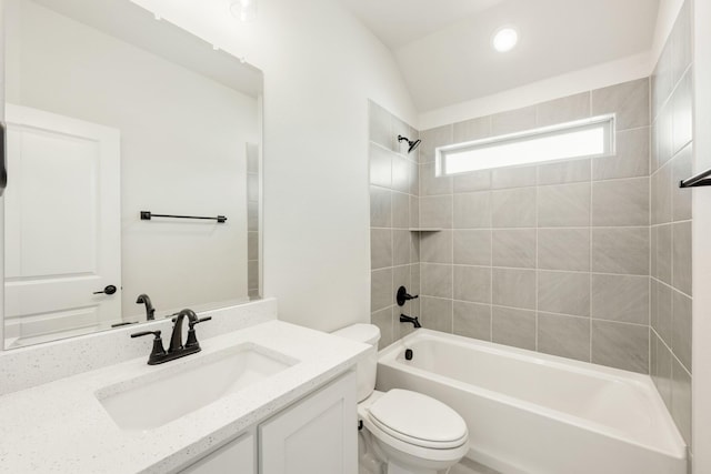 bathroom with tub / shower combination, vanity, and toilet