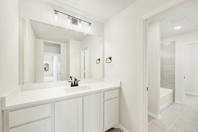 full bath featuring visible vents, tile patterned floors, vanity, and baseboards