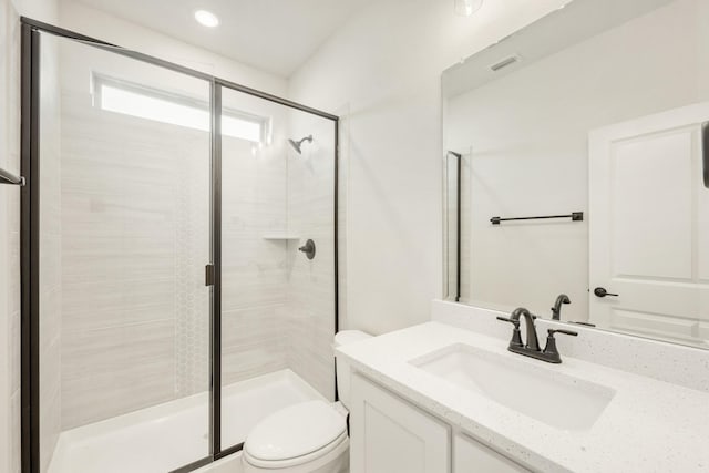 bathroom featuring visible vents, a stall shower, vanity, and toilet