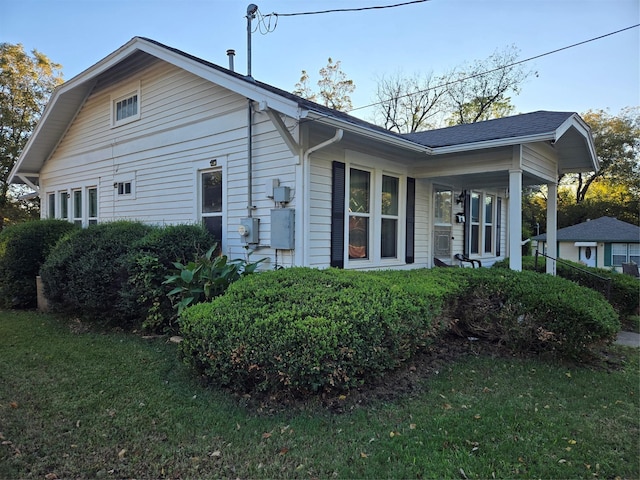 view of side of property with a lawn