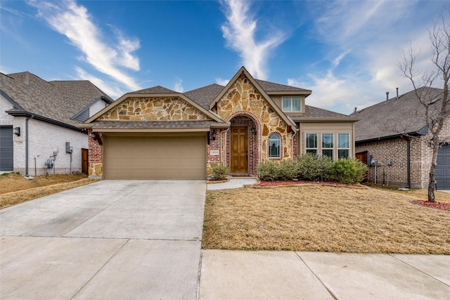 view of front of house featuring a garage and a front lawn