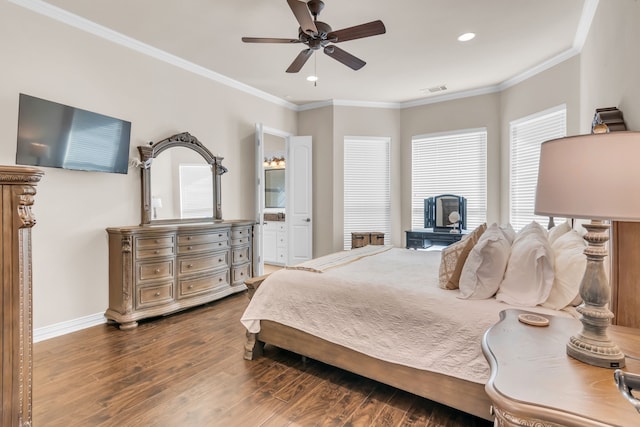 bedroom featuring crown molding, dark wood-type flooring, ceiling fan, and ensuite bathroom