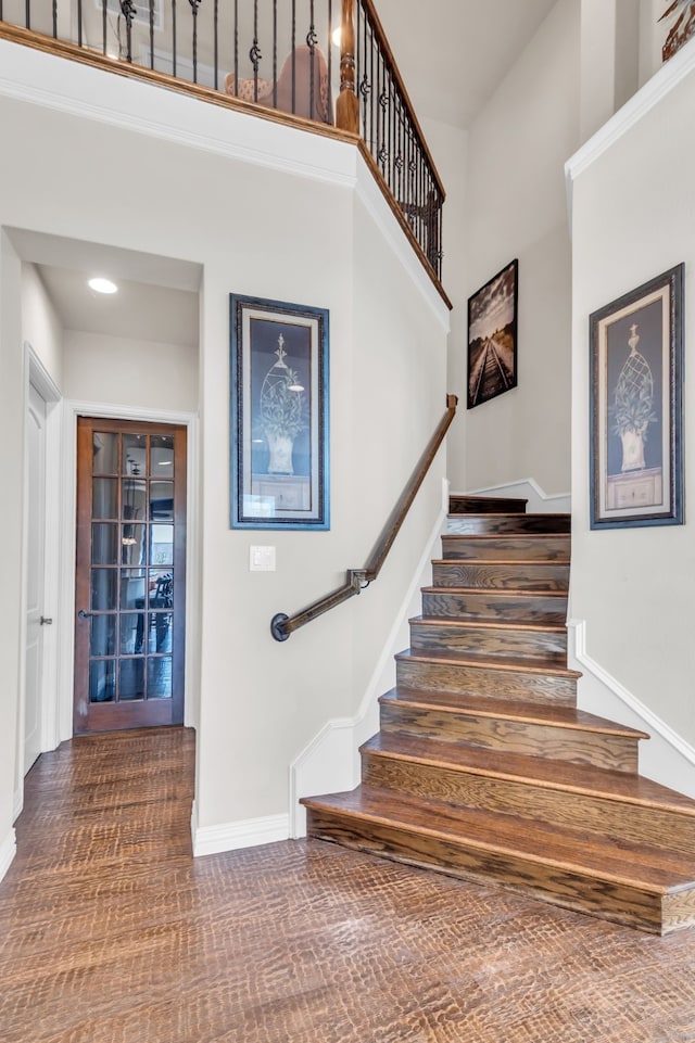 staircase featuring a high ceiling