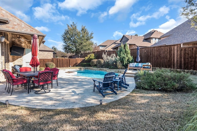 view of pool with an outdoor fire pit, a patio, and a lawn