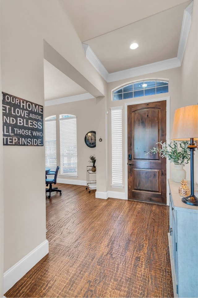 entrance foyer with crown molding and dark wood-type flooring