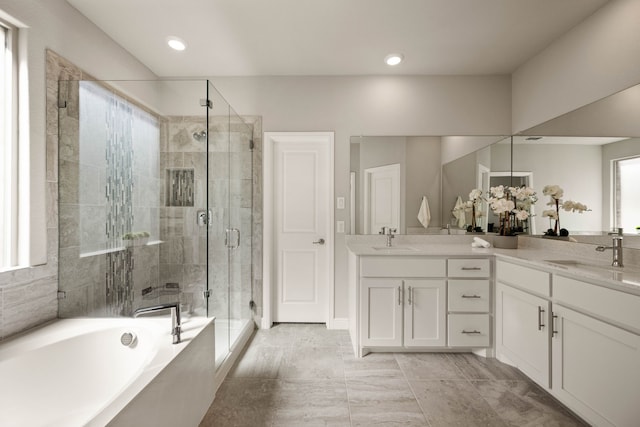1504 Longspur Dr, Argyle, TX 76226 - full bathroom featuring double vanity, a stall shower, a bath, plenty of natural light, and recessed lighting