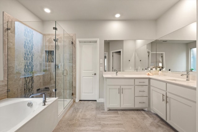 bathroom featuring tile patterned floors, vanity, and shower with separate bathtub