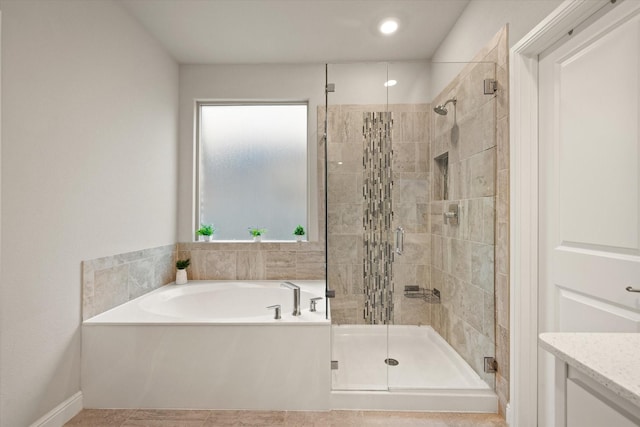 bathroom with tile patterned flooring and separate shower and tub