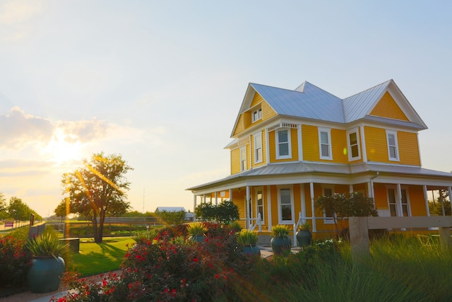 property exterior at dusk featuring a porch