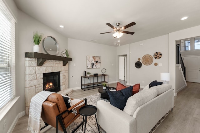 1504 Longspur Dr, Argyle, TX 76226 - living room featuring stairway, a stone fireplace, ceiling fan, light wood-style flooring, and recessed lighting