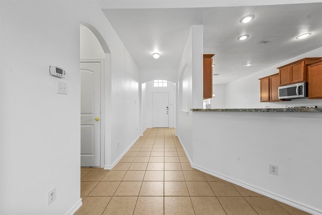 hallway with light tile patterned floors