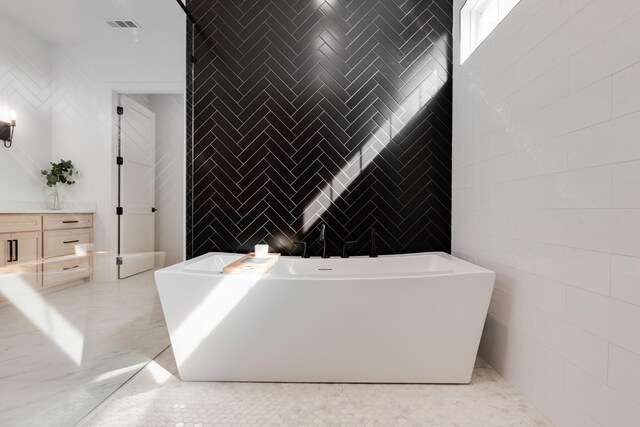 bathroom with vanity and tile walls