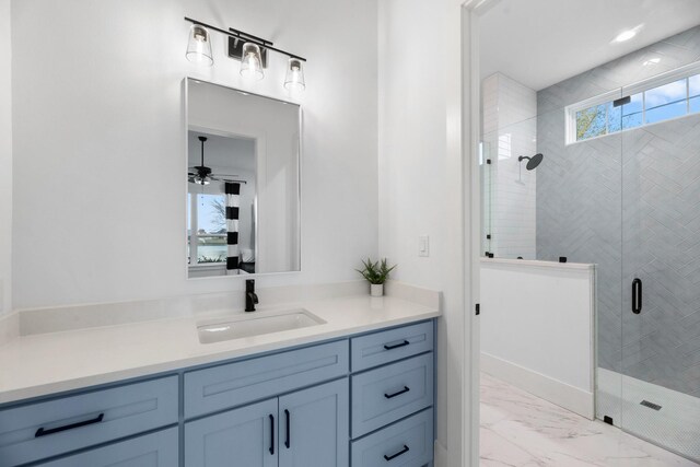 bathroom featuring ceiling fan, vanity, and a shower with shower door