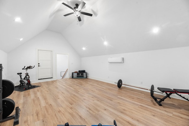 exercise room with light hardwood / wood-style floors, an AC wall unit, ceiling fan, and vaulted ceiling