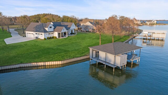 dock area with a lawn and a water view