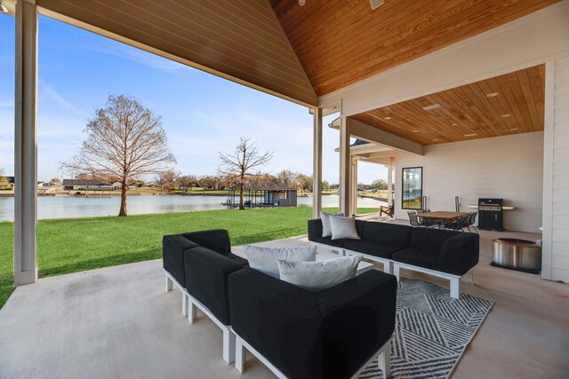 view of patio featuring area for grilling, an outdoor living space, and a water view