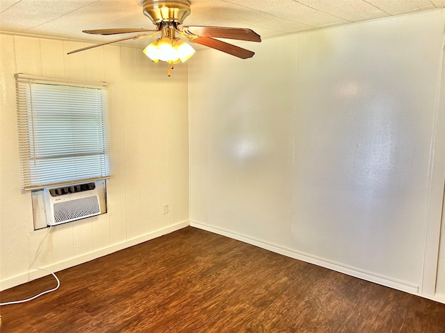 spare room with ceiling fan, cooling unit, and dark hardwood / wood-style floors