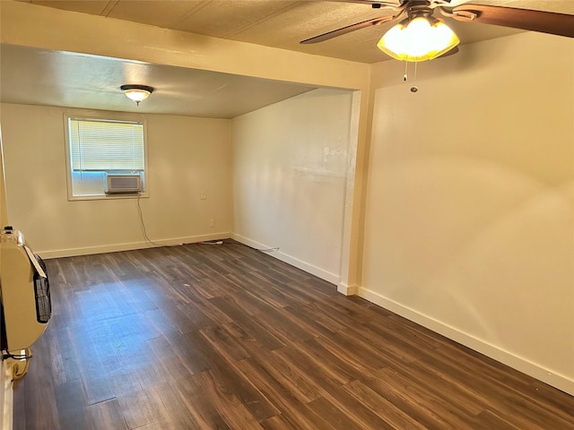 empty room with ceiling fan and dark hardwood / wood-style flooring