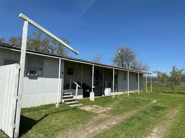 back of house with a lawn