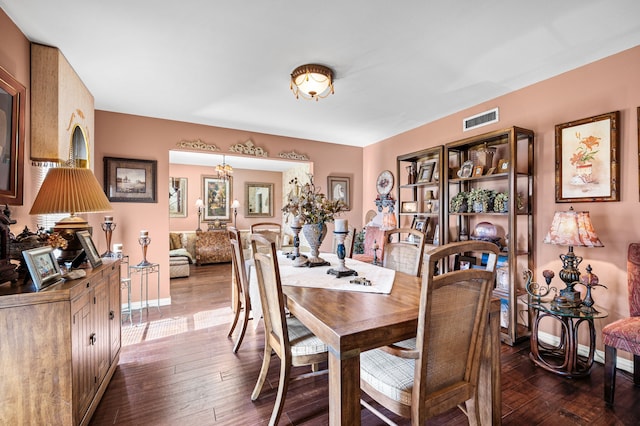 dining room featuring an inviting chandelier and dark hardwood / wood-style flooring