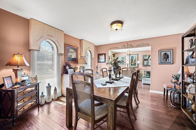 dining room featuring dark wood-type flooring and a notable chandelier