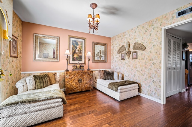 living room featuring a chandelier and dark hardwood / wood-style flooring