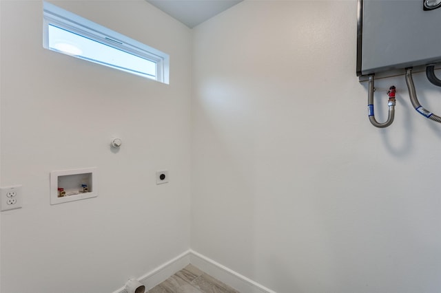 clothes washing area with electric dryer hookup, hookup for a washing machine, and gas dryer hookup