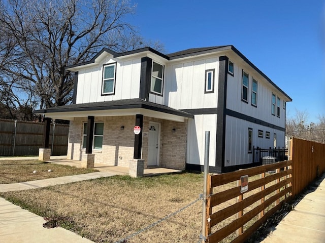 view of front of house featuring a porch and central AC