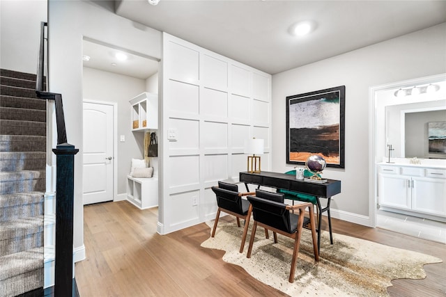 dining space with sink and light hardwood / wood-style flooring