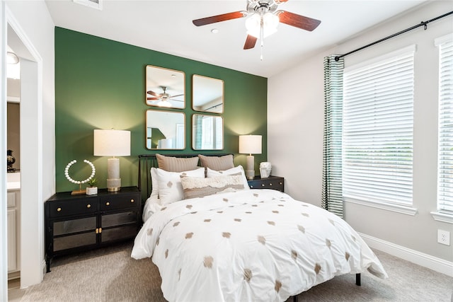 bedroom featuring light colored carpet and ceiling fan