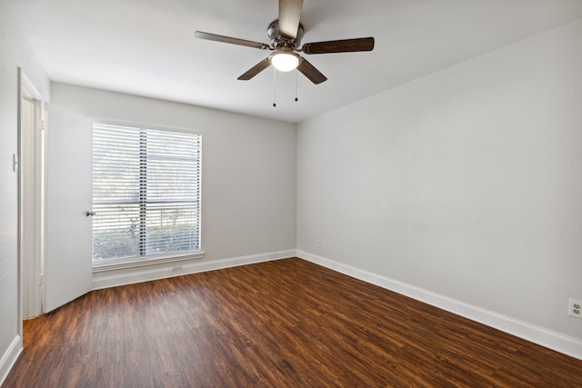 empty room with dark hardwood / wood-style flooring and ceiling fan