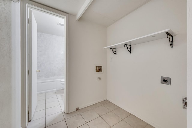 laundry area with hookup for a washing machine, hookup for an electric dryer, and light tile patterned floors