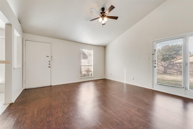 interior space featuring dark wood-type flooring, ceiling fan, and vaulted ceiling