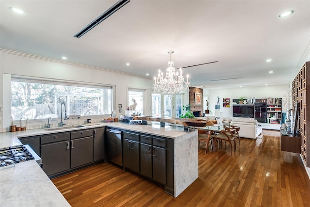 kitchen with a notable chandelier, dishwasher, dark hardwood / wood-style floors, and a fireplace