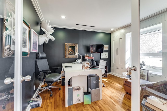 home office featuring plenty of natural light, light wood-type flooring, and ornamental molding