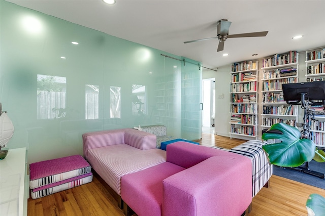 sitting room featuring ceiling fan and hardwood / wood-style floors