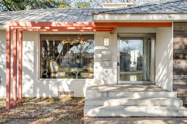 4165 Meadowdale Ln, Dallas, TX 75229 - doorway to property with a standing seam roof, stucco siding, and metal roof