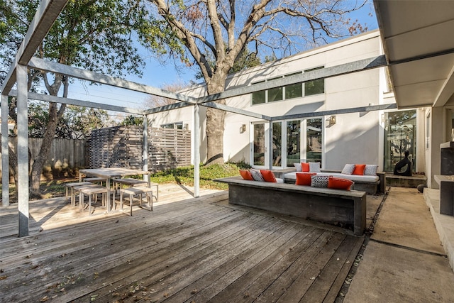 wooden terrace with an outdoor living space