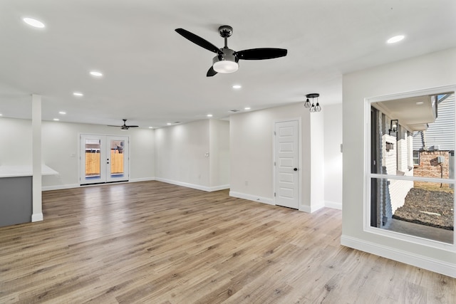 unfurnished living room with ceiling fan, french doors, and light hardwood / wood-style floors