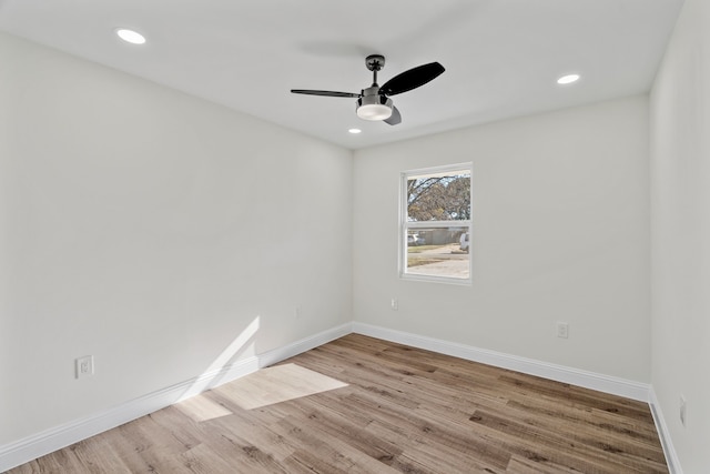 spare room featuring light hardwood / wood-style floors and ceiling fan