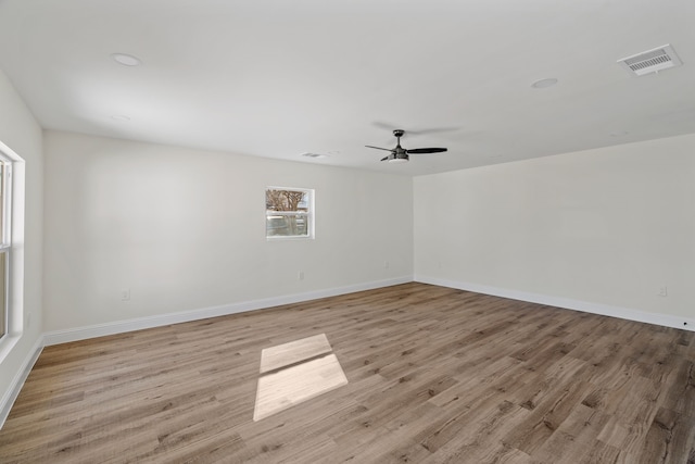 empty room featuring ceiling fan and light hardwood / wood-style flooring