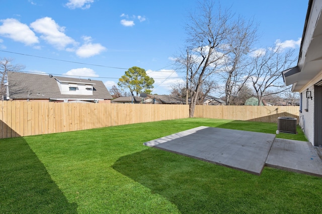 view of yard with central AC unit and a patio